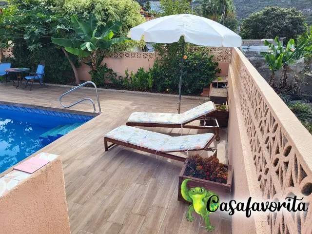 BookNoFees self catering holiday home in Buen Paso, Tenerife, Spain – Pool terrace with sun loungers, umbrella, and tiled deck