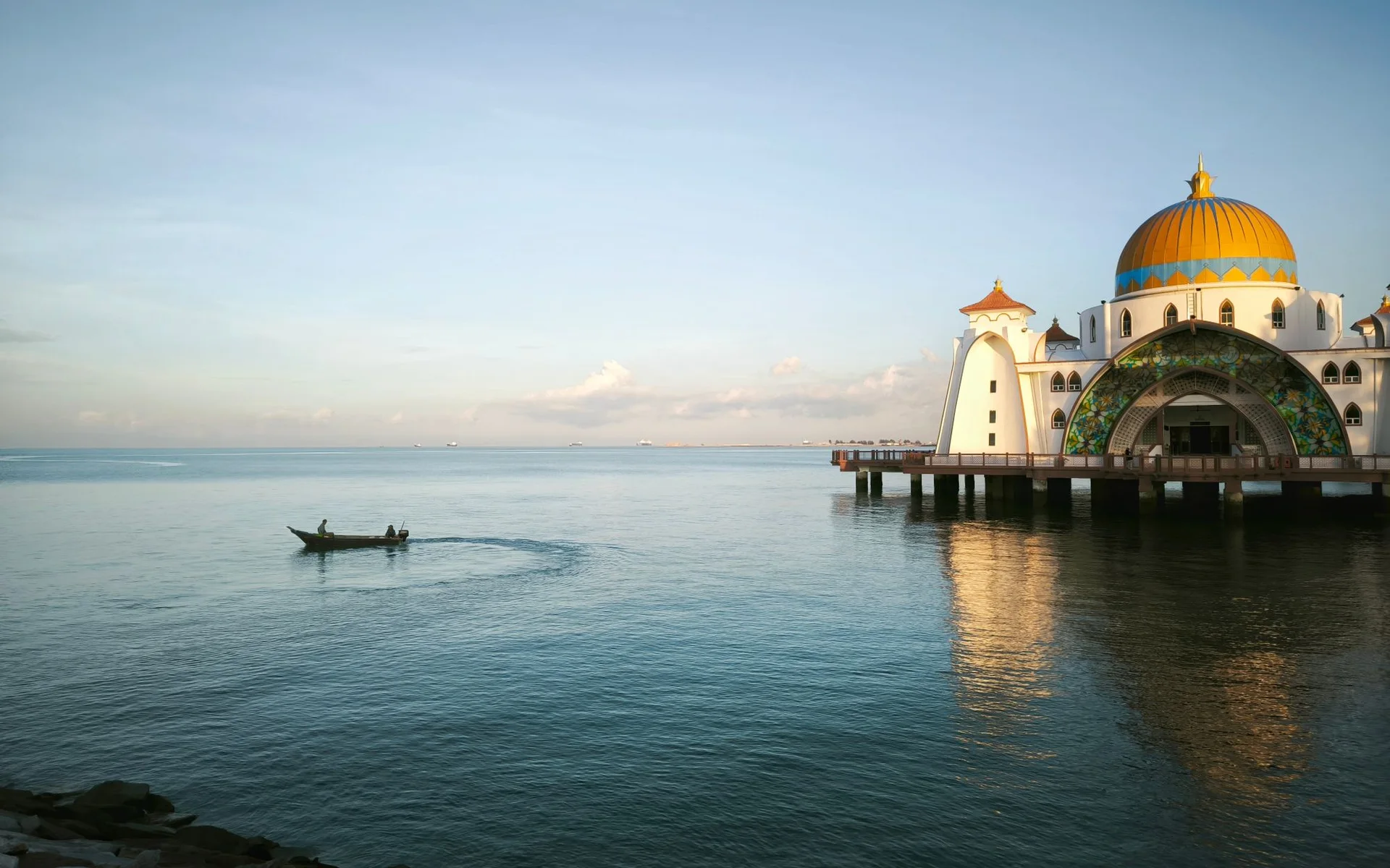 Malacca Street Mosque and a fishing boat by the water