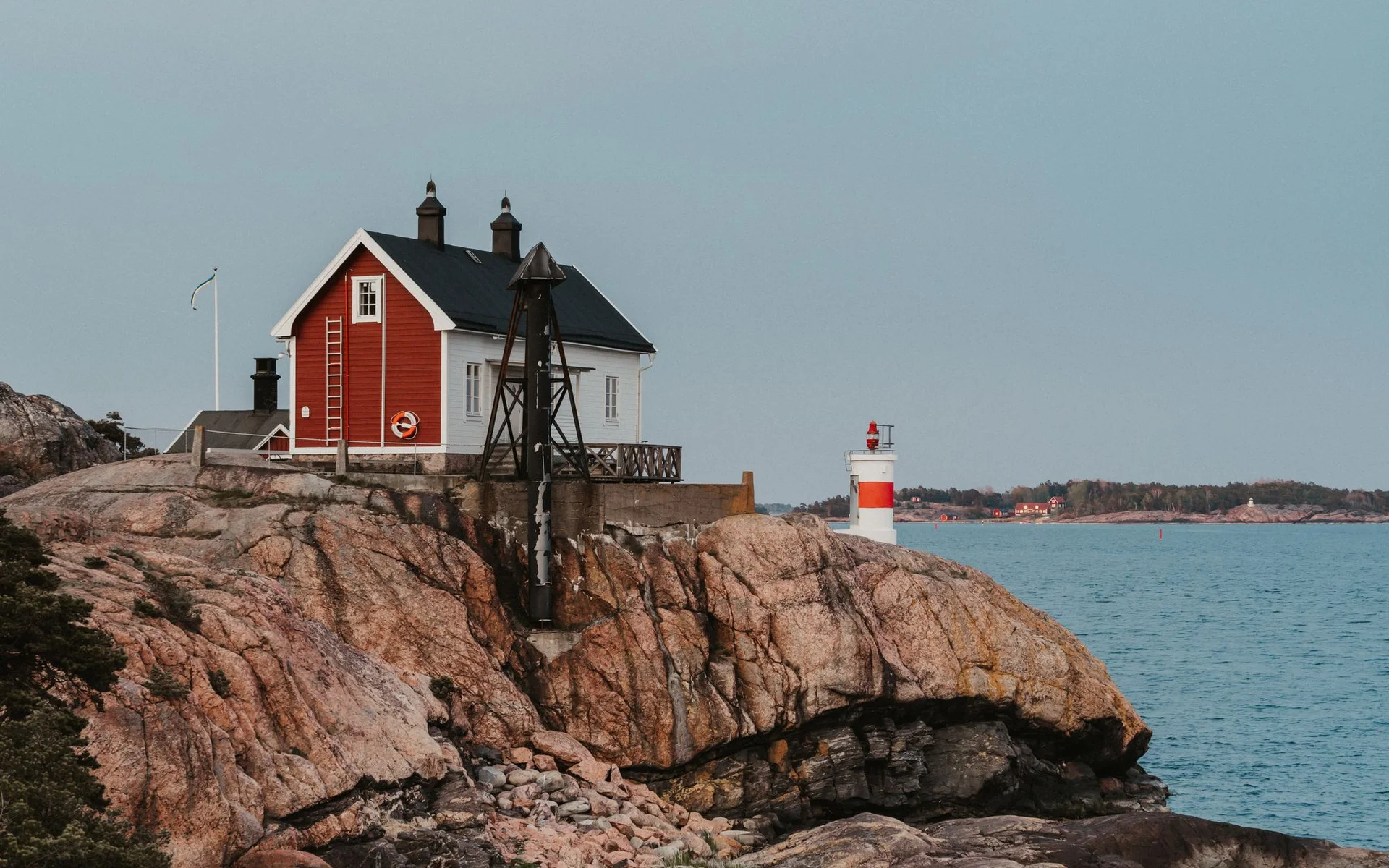 Red House and Lighthouse on Sweden’s Rocky Coast