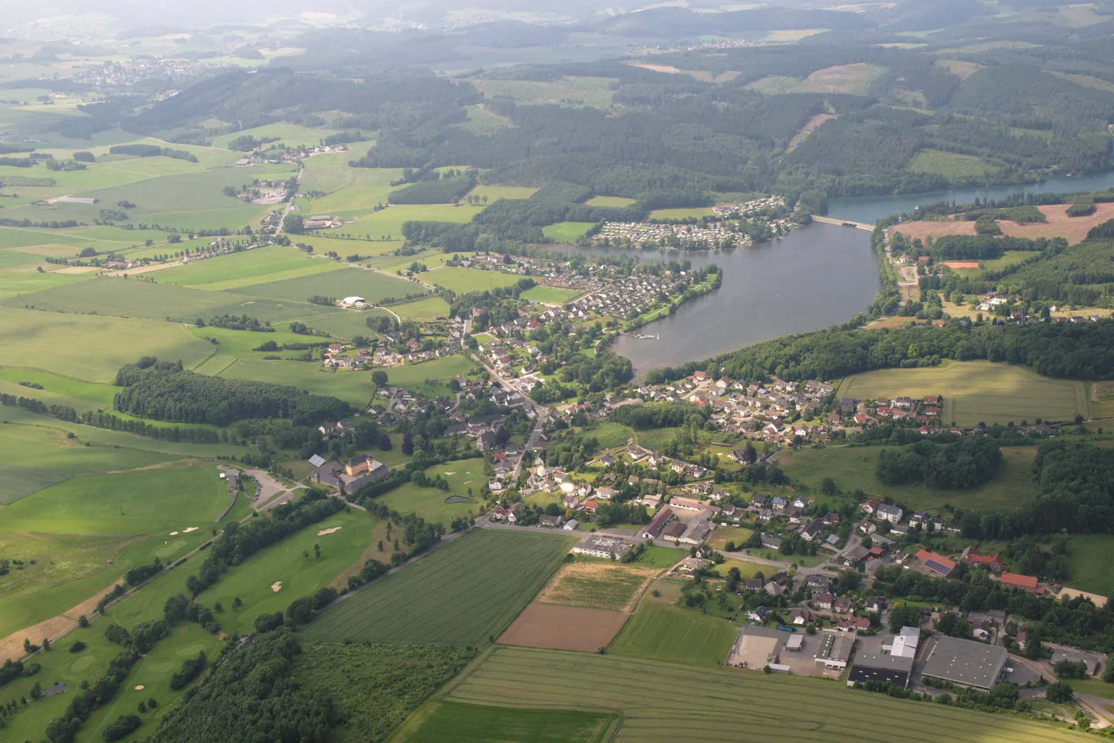 The Sorpesee from the air, with the village of Amecke on its eastern shore and the wooded Sauerland hills around it