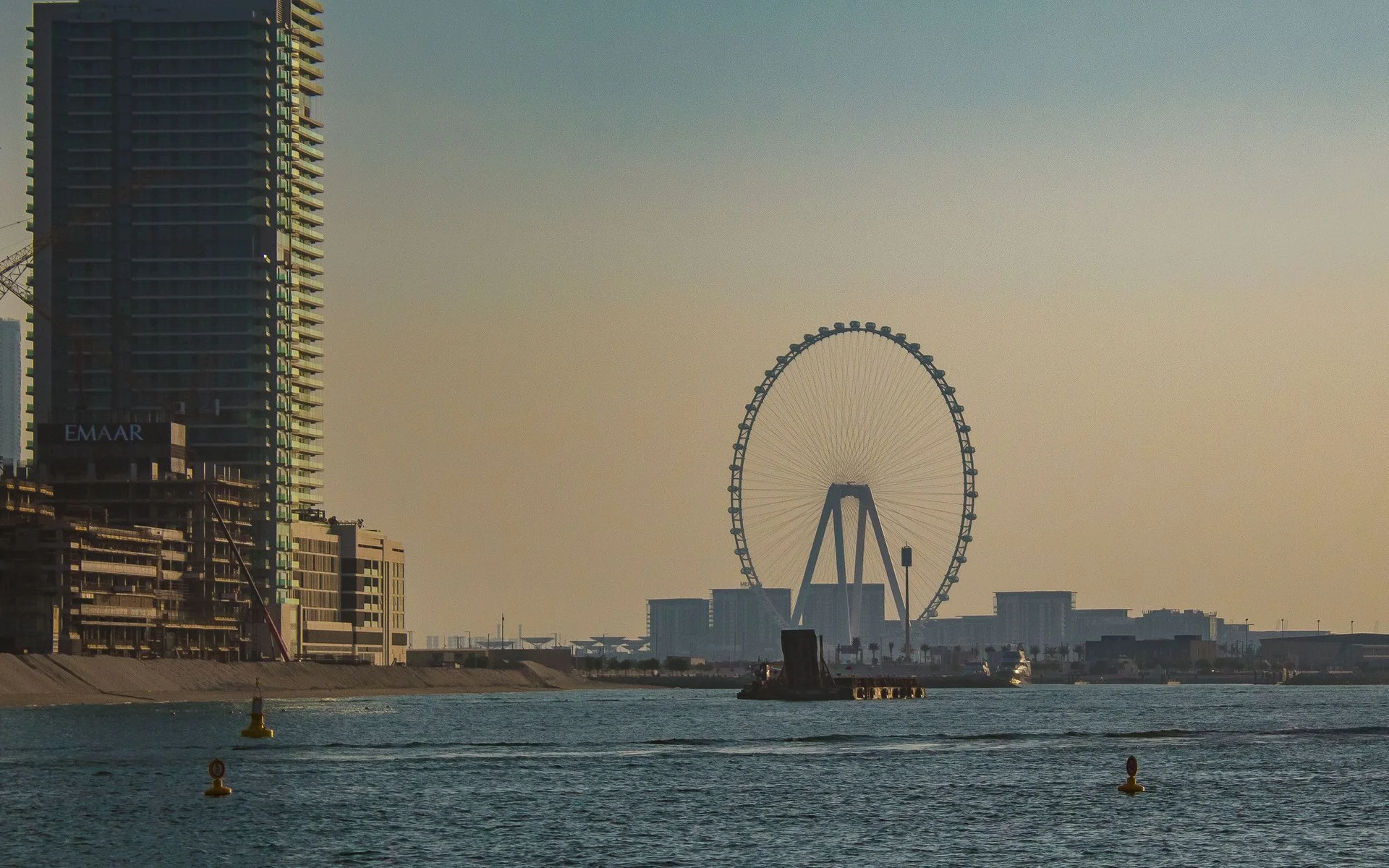 Dubai skyline with the Ferris wheel at sunset